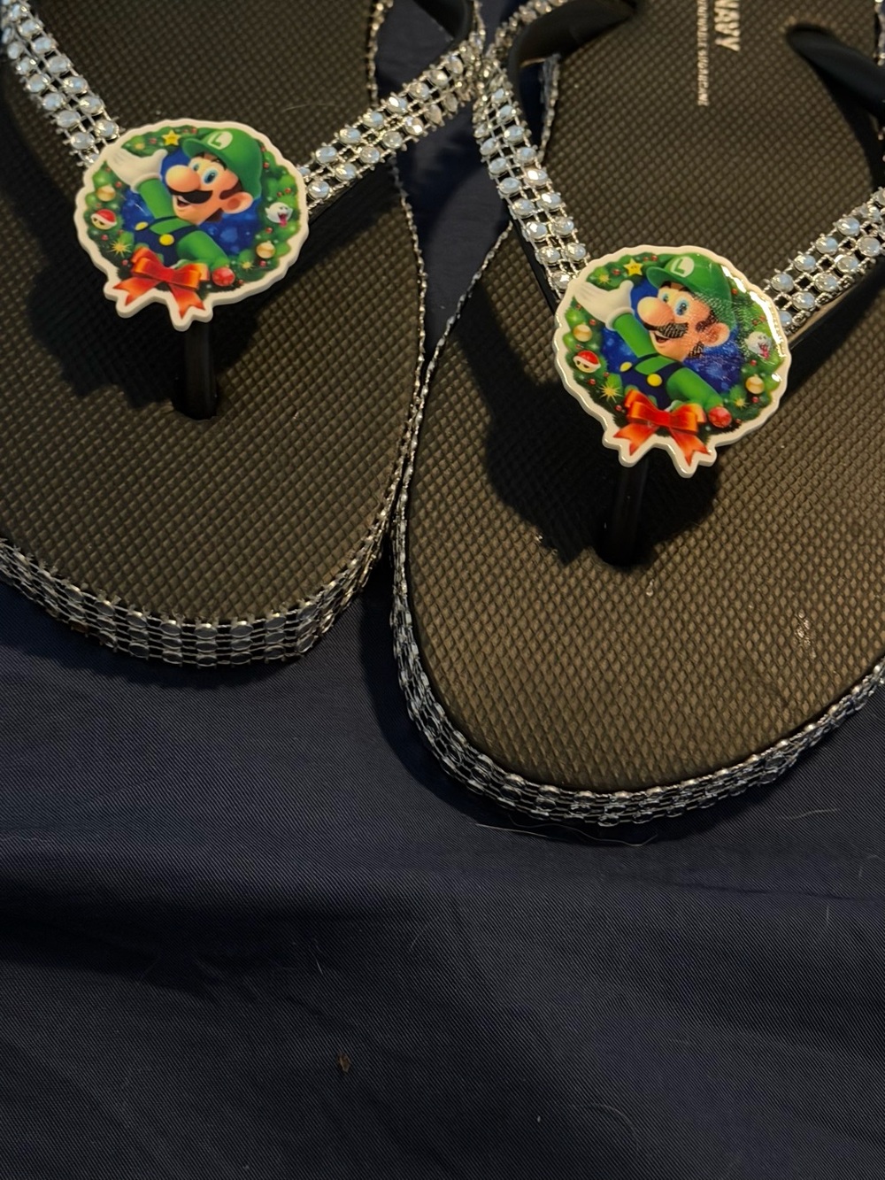 Black Rhinestone-Trim Flip Flops with Green Character Accent